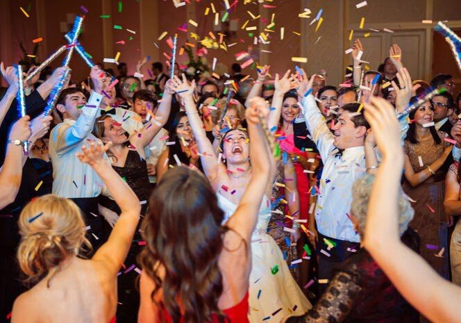 People celebrating with confetti and lights